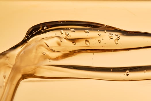 Tasty texture of cosmetic gel on a golden background. photo