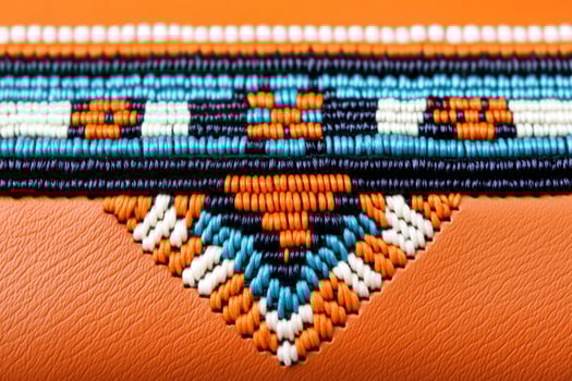 Close-up view of vibrant Native American beadwork on leather pouch highlighting intricate patterns and craftsmanship photo