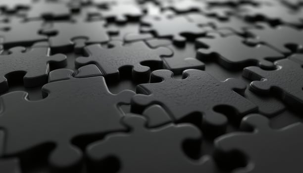 Intricate Black Puzzle Pieces Interlocked Creating a Textured Surface with Depth photo