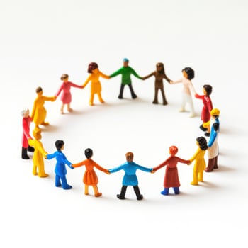 Colorful figurines form a circle holding hands, symbolizing unity and diversity at a community gathering in a bright setting photo