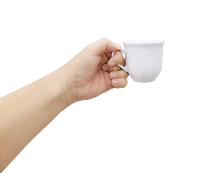 One hand holds a white ceramic coffee cup. photo