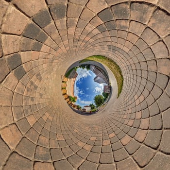 blue sphere overlooking old town, urban development, historic buildings surrounded by a frame of paving slabs. Transformation of spherical 360 panorama in abstract aerial view. photo