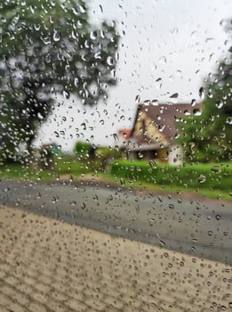 Rainy day, wet glass with raindrops, a look through wet glass. photo