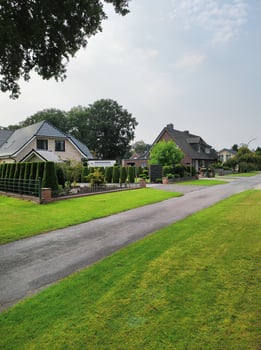 Beautiful street view after rain with green grass and cloudy skies. photo
