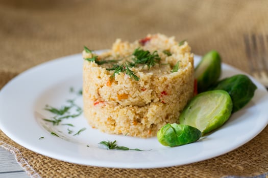 Diet recipe,homemade cooked bulgur with Brussel sprouts in a plate, on a wooden table photo