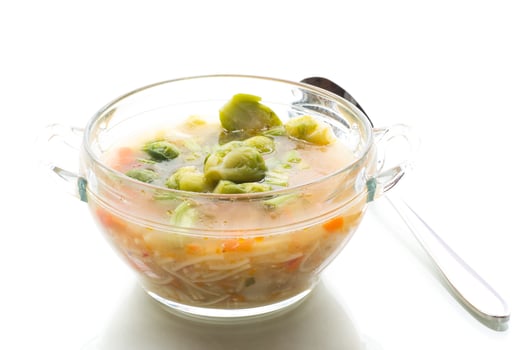 Natural vegetable soup with brussels sprouts, isolated on white background photo