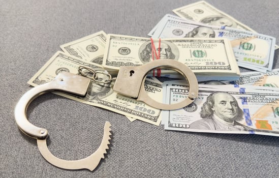 American dollars and handcuffs, Concept of ideas of corruption, dirty money or financial crimes. photo