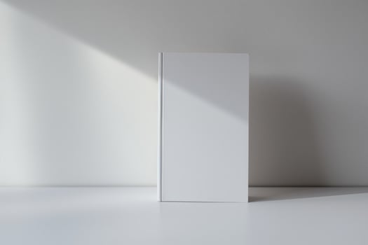 Minimalist Blank White Book on Clean Surface with Subtle Shadow Play photo