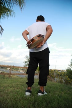 Happy Tambourine Player Performing in Fields photo