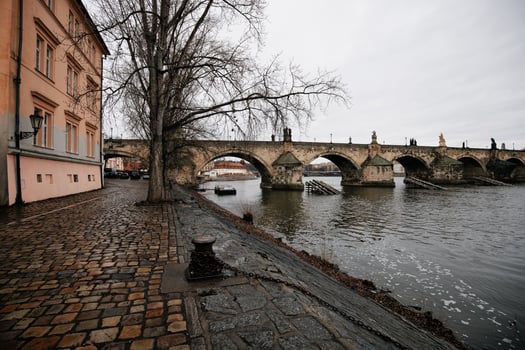 Charles bridge in prague connecting shores on cloudy day Kampa photo