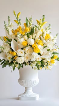 A striking arrangement of yellow and white flowers set in an elegant vase photo