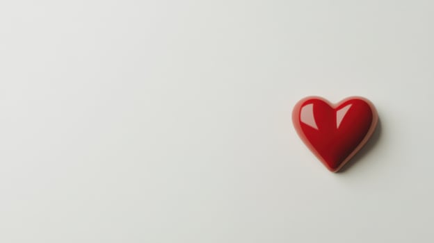 Red heart shaped object on white background for love and romance concept photo