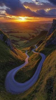 Sunset over winding road in lush valley with hills and scenic landscape photo