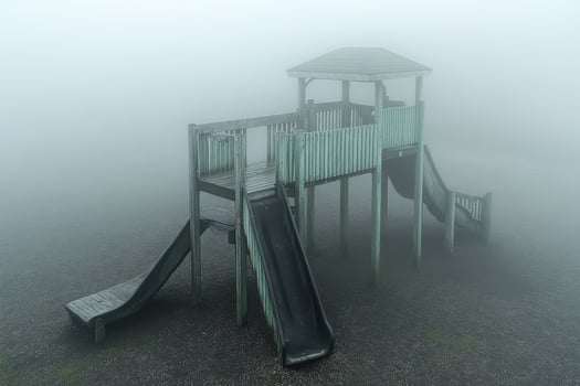 Foggy Playground Wooden Structure With Slides photo