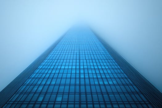 Glass Skyscraper Rising Through Misty Sky photo