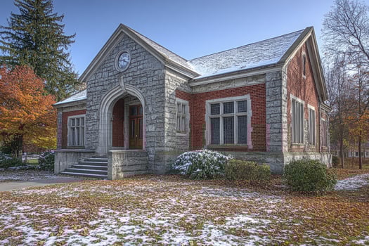 Stone and Brick Building Autumn Leaves Light Snow photo