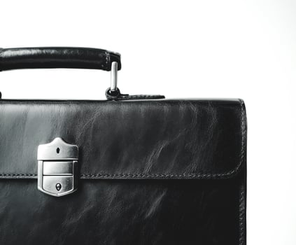 Sleek black leather briefcase showcasing craftsmanship against a minimalistic background photo