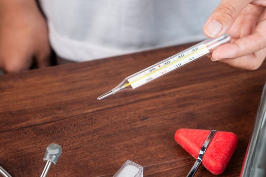 Thermometer and Medical Tools on a Wooden Table photo