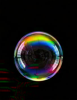 Single bubble with rainbow reflection in a black background photo