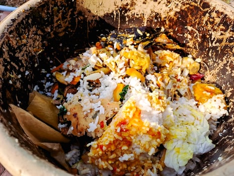A bowl of food that has been sitting on the ground photo
