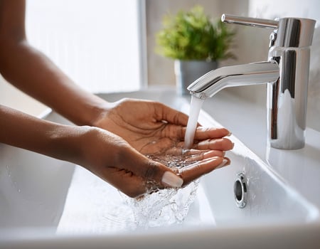 Healthy Habit. Close-Up of Female Hands Being Washed Under Tap Water photo