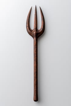 Antique trident shaped fork on white background photo