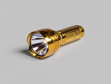 Gold flashlight on gray background photo