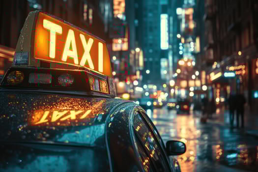 Yellow taxi cab sign illuminating rainy new york city street at night. photo