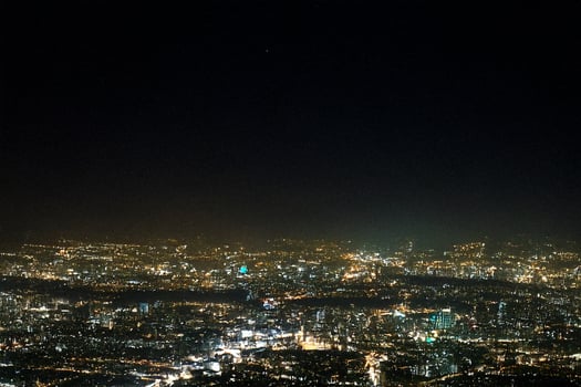 Night city lights viewed from mountaintop photo