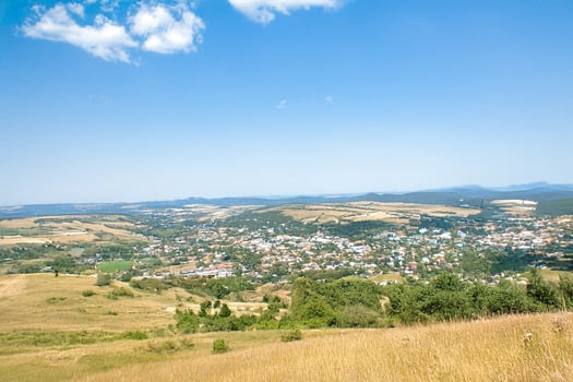 Hilltop view of rural town, sunny day, travel brochure photo