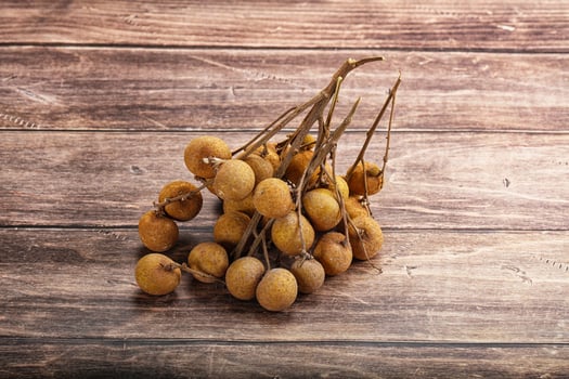 A bunch of ripe fruit on a wooden table photo