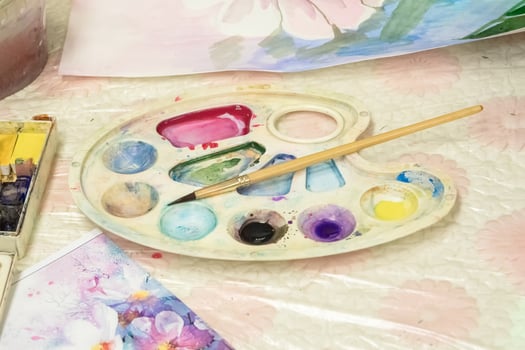 Brush and watercolor palette on the dirt table. Paints and brushes for drawing. photo