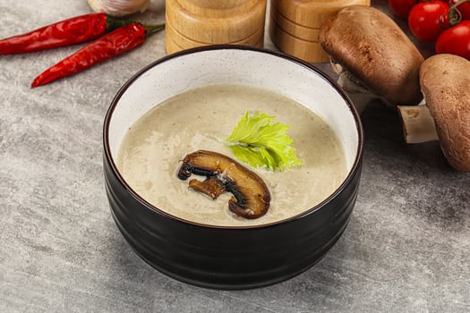 A bowl of soup with mushrooms and vegetables photo