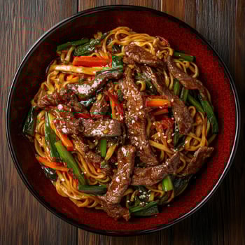 Delicious beef stir-fry with vegetables and noodles in a vibrant bowl photo