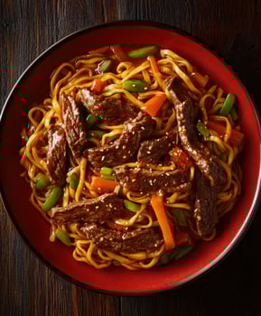Delicious stir-fry noodles with beef and vegetables in a vibrant bowl photo