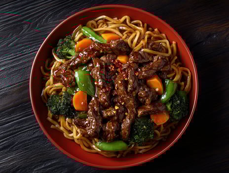 Savory beef stir-fry with vegetables and noodles in vibrant bowl photo
