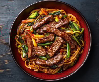 Delicious beef stir fry with vegetables served in a bowl photo