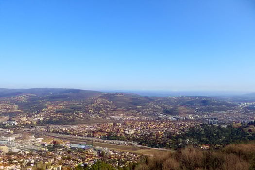 Hilltop Cityscape View Panoramic autumnal urban sprawl under clear skies photo