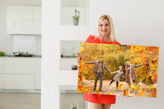 woman holding a photo of autumn, canvas