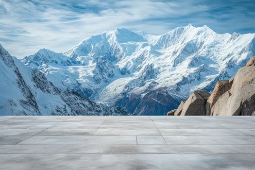 An empty concrete floor with a mountain range in the background photo