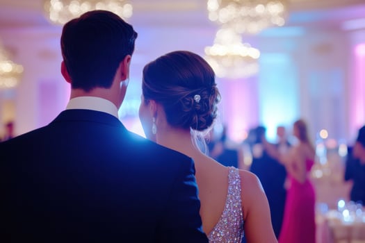 Elegant charity gala attendees enjoy a night of dancing and celebration in a beautifully lit venue with pink decorations photo