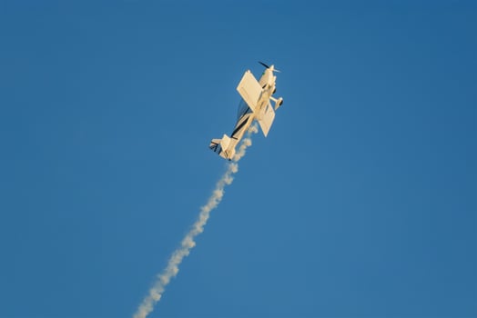 Stunt aerobatic plane performing stunts in air photo