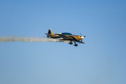 Stunt aerobatic plane performing stunts in air photo