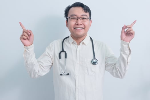 happy Asian man doctor, nurse pointing pose isolated white background. photo
