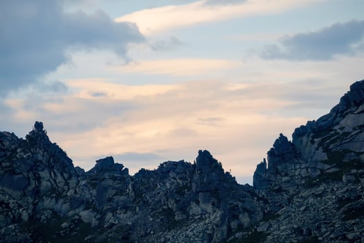 Sharp jagged mountain wall at sunset. photo