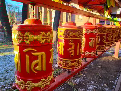 Prayer wheels in Buddhist temple. turning spinning prayer wheel at Buddhist monastery. Buddhism religion concept photo