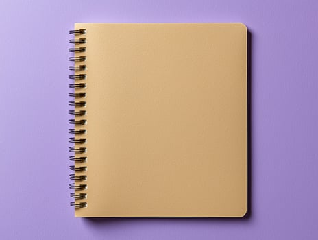 Blank spiral notebook on purple background photo
