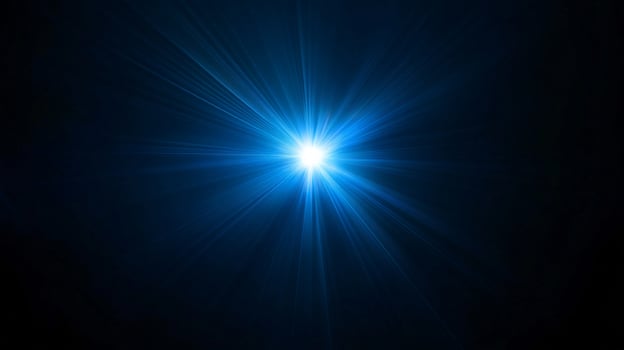 Bright starburst of radiant light in deep blue space photo