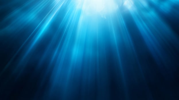 Ethereal blue light rays streaming through watery depths photo