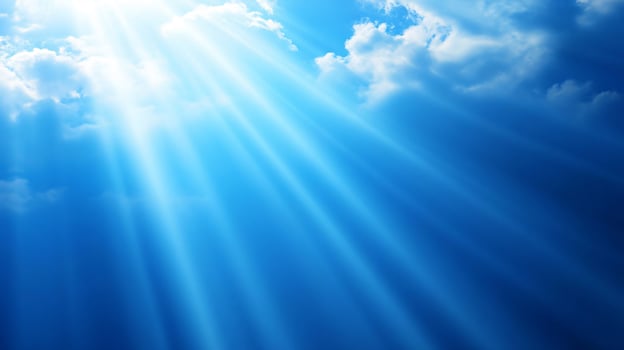 Sunlight beams breaking through clouds high in sky photo